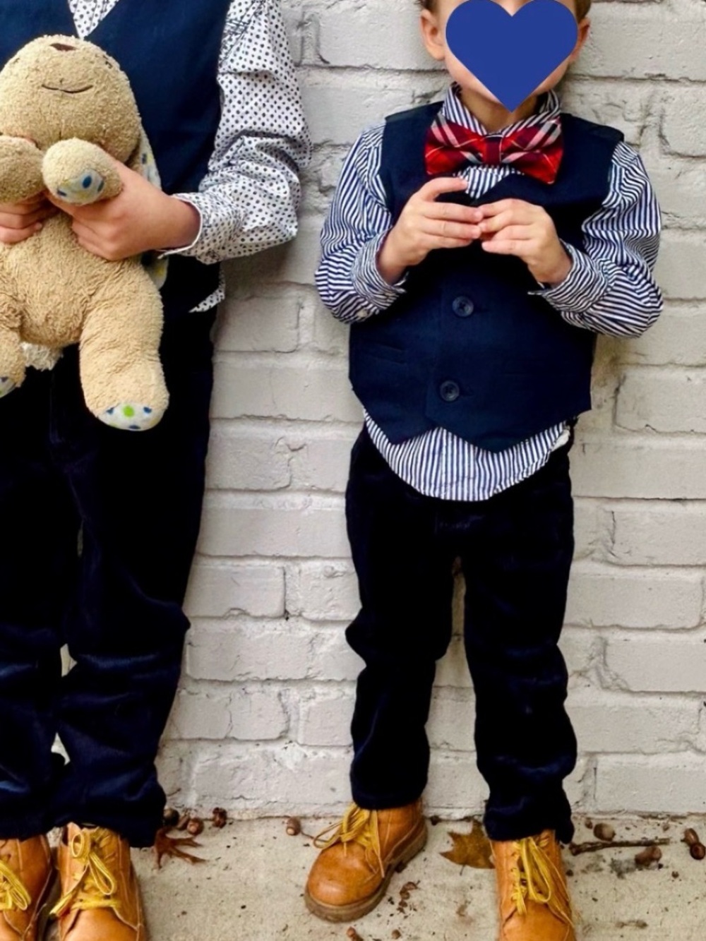 Kids navy corduroy pants, vest, and striped polo shirt.